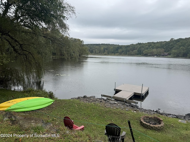 view of dock with a water view and an outdoor fire pit