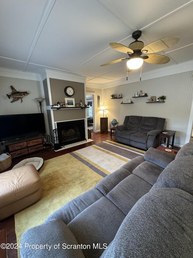 living room with ceiling fan, crown molding, and wood-type flooring