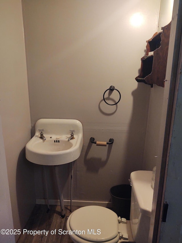 bathroom featuring hardwood / wood-style floors and toilet