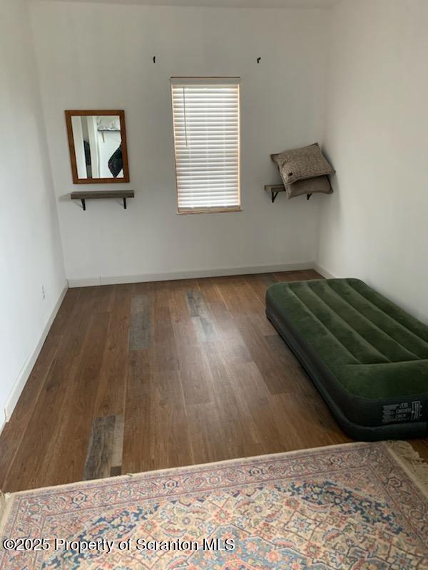 unfurnished room with hardwood / wood-style floors