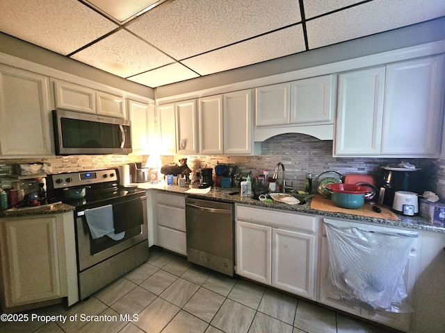 510 Moltke Ave, Scranton, PA 18505 - kitchen featuring stainless steel appliances, a drop ceiling, light tile patterned floors, a sink, and decorative backsplash
