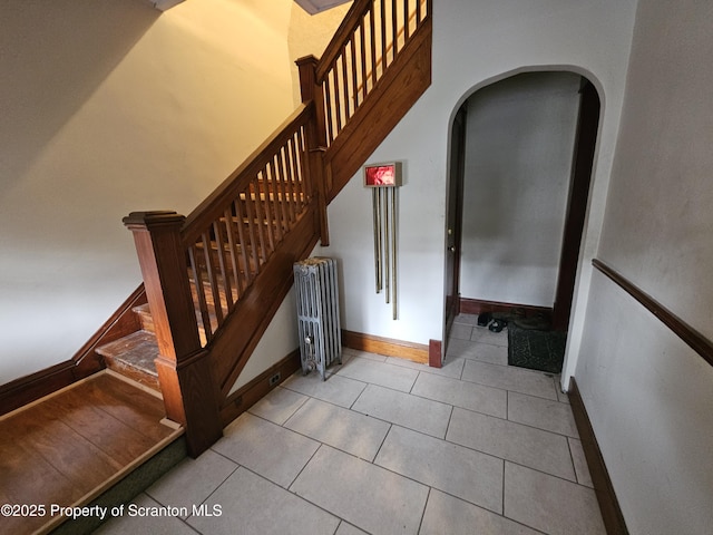 510 Moltke Ave, Scranton, PA 18505 - stairway featuring radiator, arched walkways, tile patterned flooring, and baseboards