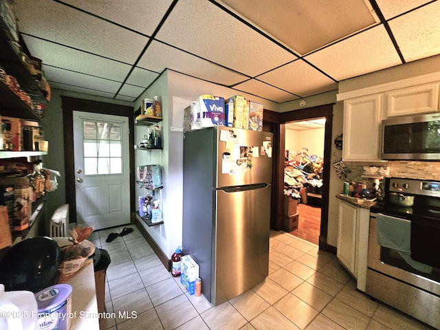 510 Moltke Ave, Scranton, PA 18505 - kitchen with stainless steel appliances, a paneled ceiling, light tile patterned flooring, and tasteful backsplash