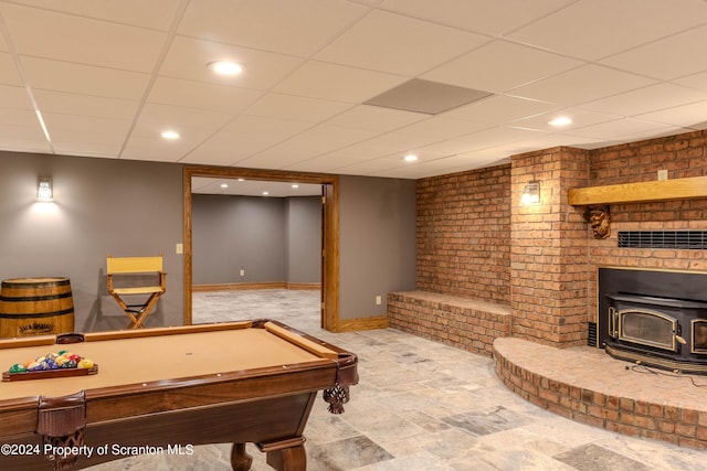 playroom featuring a wood stove, a paneled ceiling, and billiards