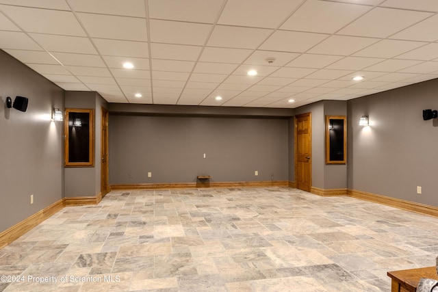 basement featuring a paneled ceiling