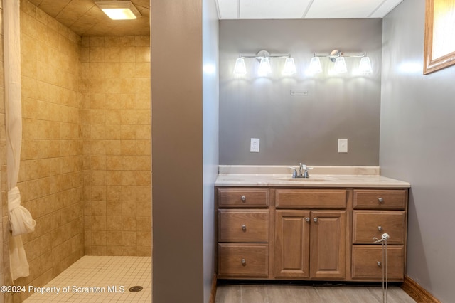 bathroom with vanity and a tile shower