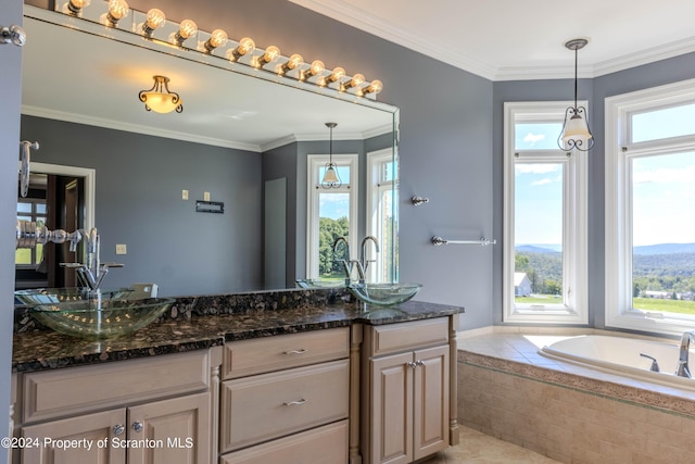 bathroom featuring vanity, a mountain view, crown molding, and tiled bath