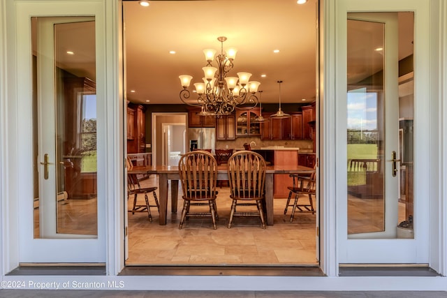 dining room with a healthy amount of sunlight and a notable chandelier