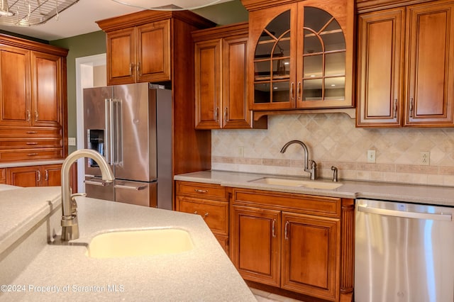 kitchen with decorative backsplash, sink, and appliances with stainless steel finishes