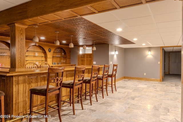 bar featuring hanging light fixtures