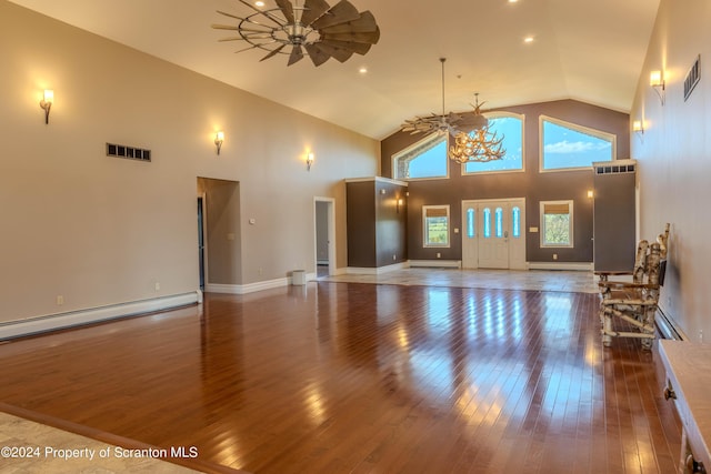 living room with ceiling fan with notable chandelier, hardwood / wood-style flooring, high vaulted ceiling, and a baseboard radiator