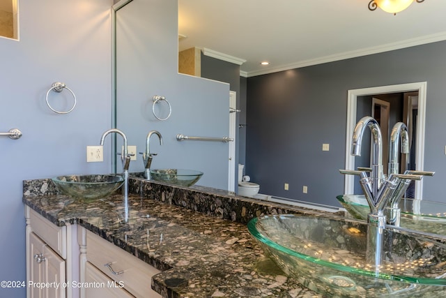 bathroom with vanity, toilet, and crown molding