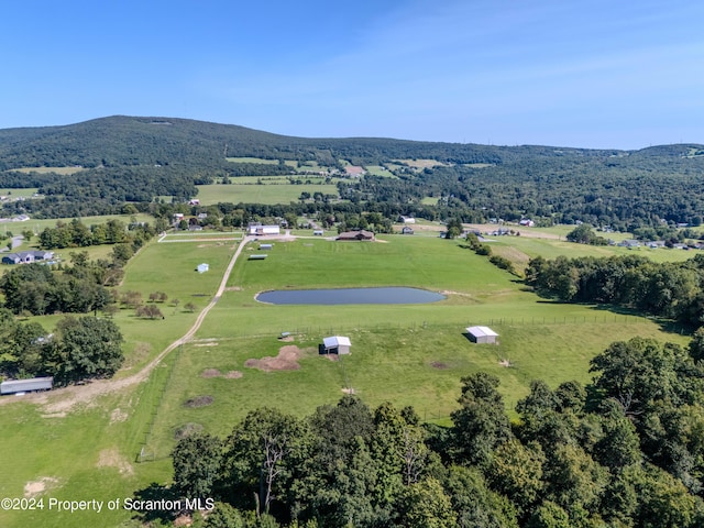 birds eye view of property featuring a water and mountain view and a rural view