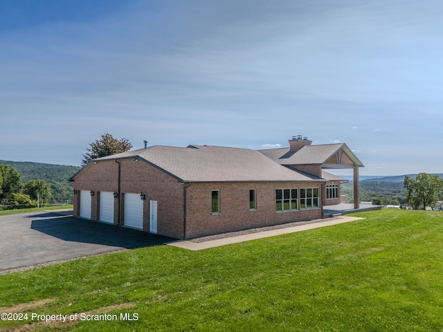 view of home's exterior with a lawn and a garage