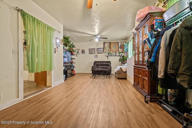 interior space with light wood finished floors and ceiling fan