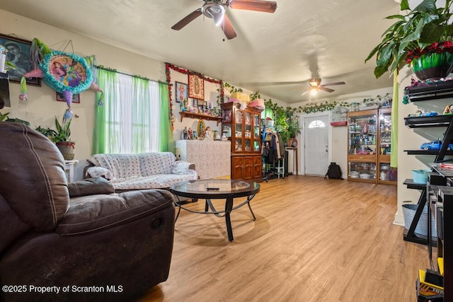 living room with light wood-type flooring and ceiling fan