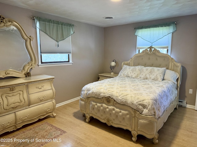 102 Bubernak Blvd, Old Forge, PA 18518 - bedroom with multiple windows, light wood-style flooring, baseboard heating, and baseboards