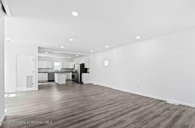 unfurnished living room featuring dark wood-type flooring