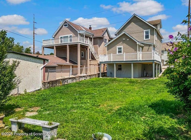 back of house with a wooden deck and a lawn