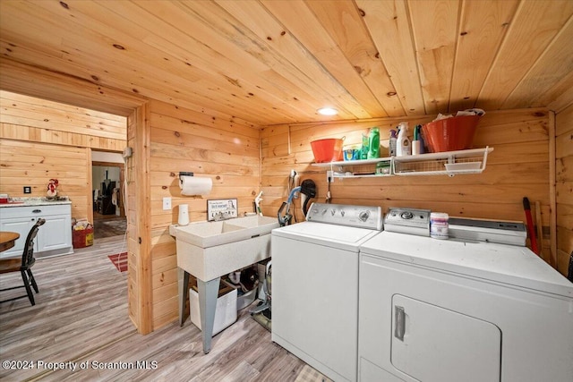 washroom with washer and dryer, light hardwood / wood-style flooring, wood walls, and wood ceiling