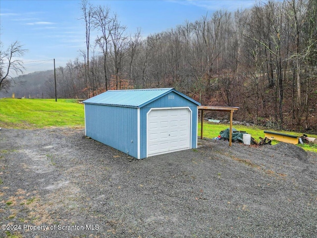 garage featuring a yard and a carport