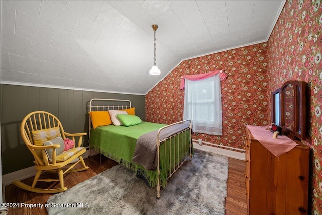 bedroom featuring dark hardwood / wood-style floors, crown molding, and vaulted ceiling