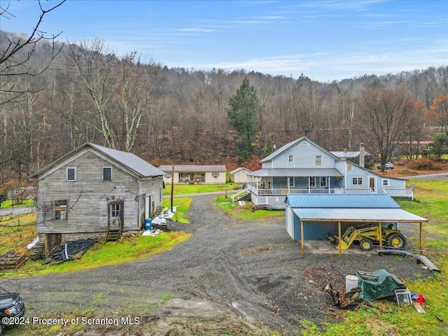 exterior space with covered porch and a carport