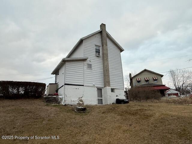 view of side of property with a yard