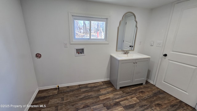 bathroom featuring vanity, wood finished floors, and baseboards