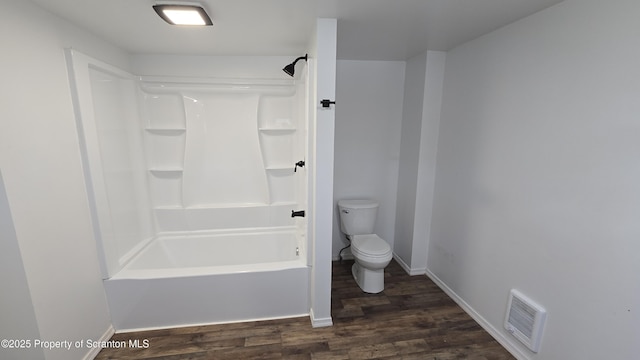 full bath with visible vents, toilet, wood finished floors, shower / bath combination, and baseboards