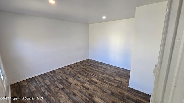 spare room with dark wood finished floors, recessed lighting, and baseboards