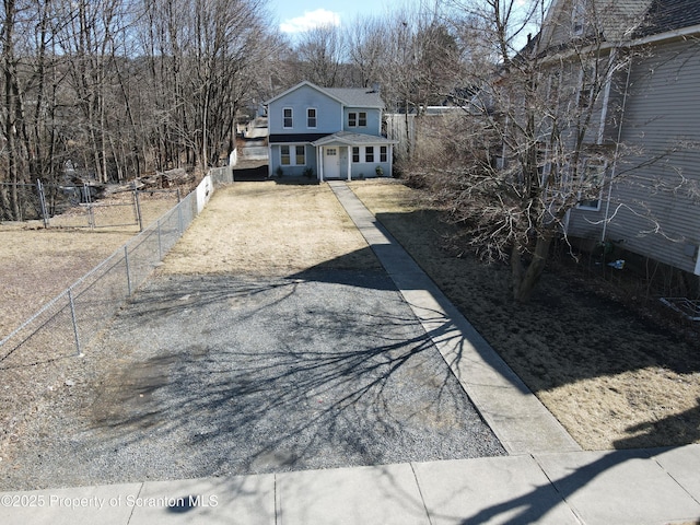 exterior space featuring driveway and fence