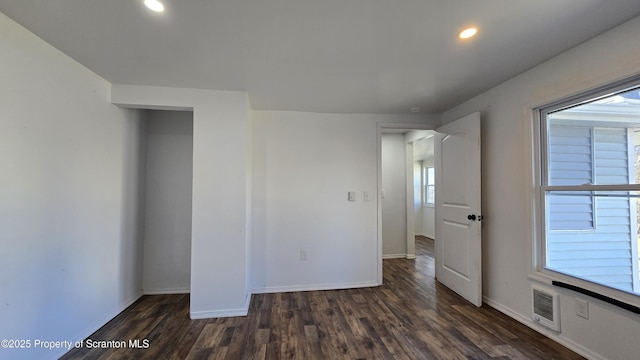 unfurnished room featuring recessed lighting, baseboards, visible vents, and dark wood-style flooring