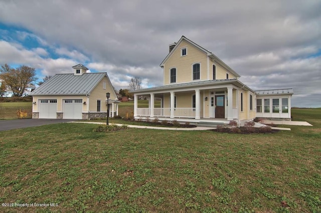 farmhouse-style home featuring a porch and a front yard