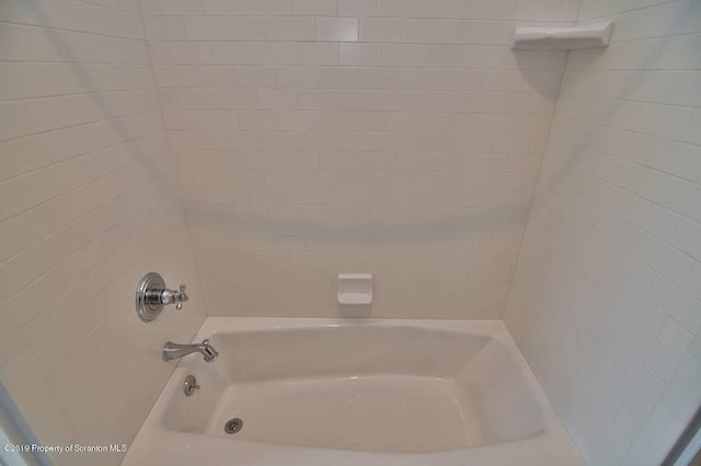 bathroom featuring tiled shower / bath