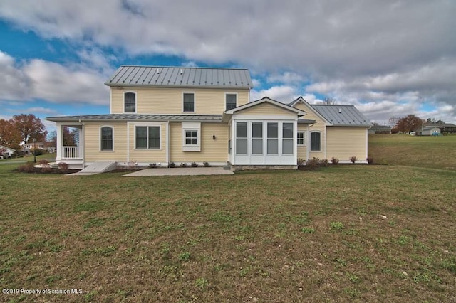 rear view of house with a yard