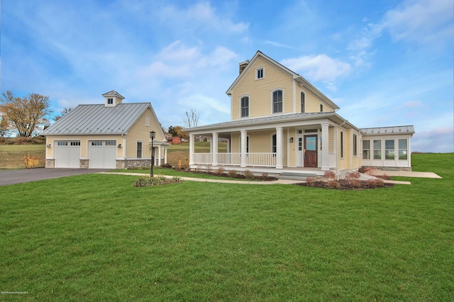 view of front facade featuring a garage, covered porch, and a front lawn