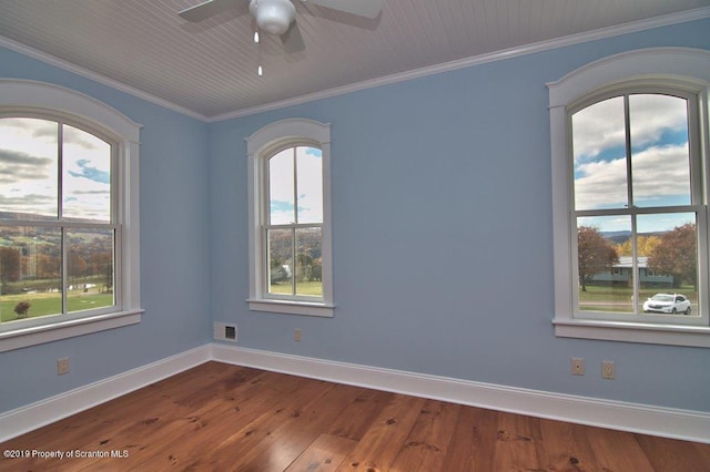 unfurnished room with crown molding, plenty of natural light, ceiling fan, and wood-type flooring