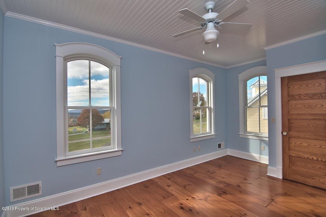 spare room featuring ceiling fan, crown molding, and dark wood-type flooring