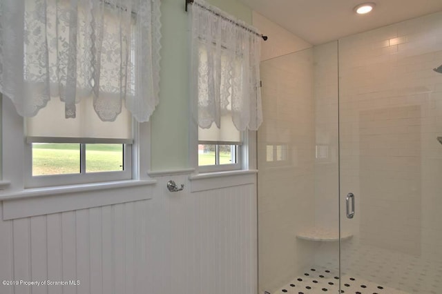 bathroom with a shower with door