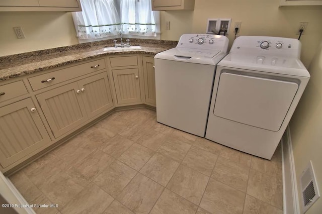 laundry room with cabinets, sink, and washing machine and clothes dryer