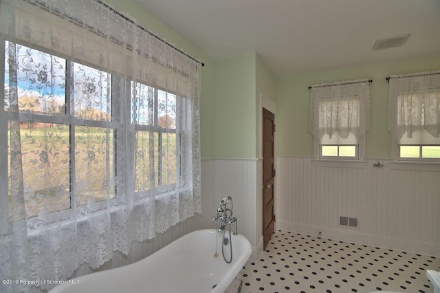 bathroom with tile patterned flooring and a bathtub