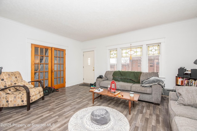 living room featuring hardwood / wood-style floors, ornamental molding, and baseboard heating