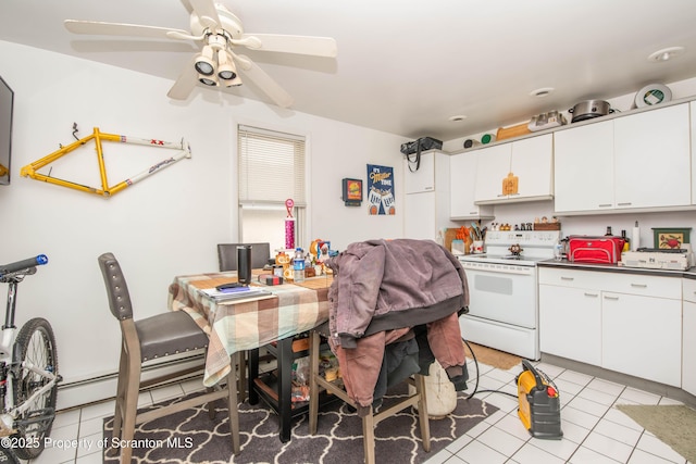 kitchen with light tile patterned floors, ceiling fan, white cabinetry, a baseboard heating unit, and electric range