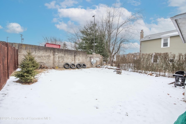 view of yard layered in snow