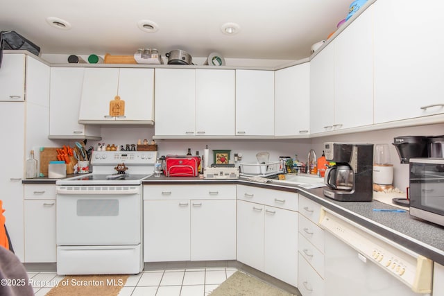 kitchen featuring sink, light tile patterned floors, white cabinets, and white appliances