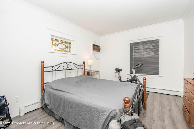 bedroom featuring a baseboard heating unit, crown molding, and light hardwood / wood-style floors