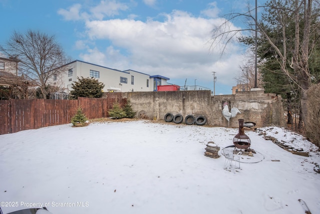 snowy yard with a fire pit