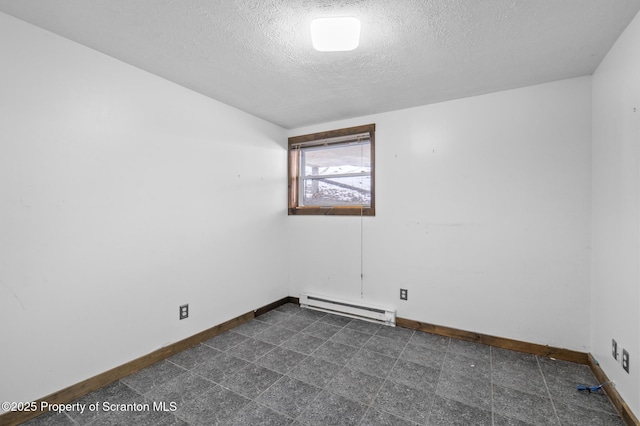 unfurnished room with a textured ceiling, dark floors, baseboard heating, and baseboards