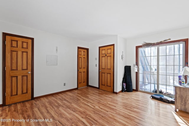 interior space with light wood-style flooring and baseboards